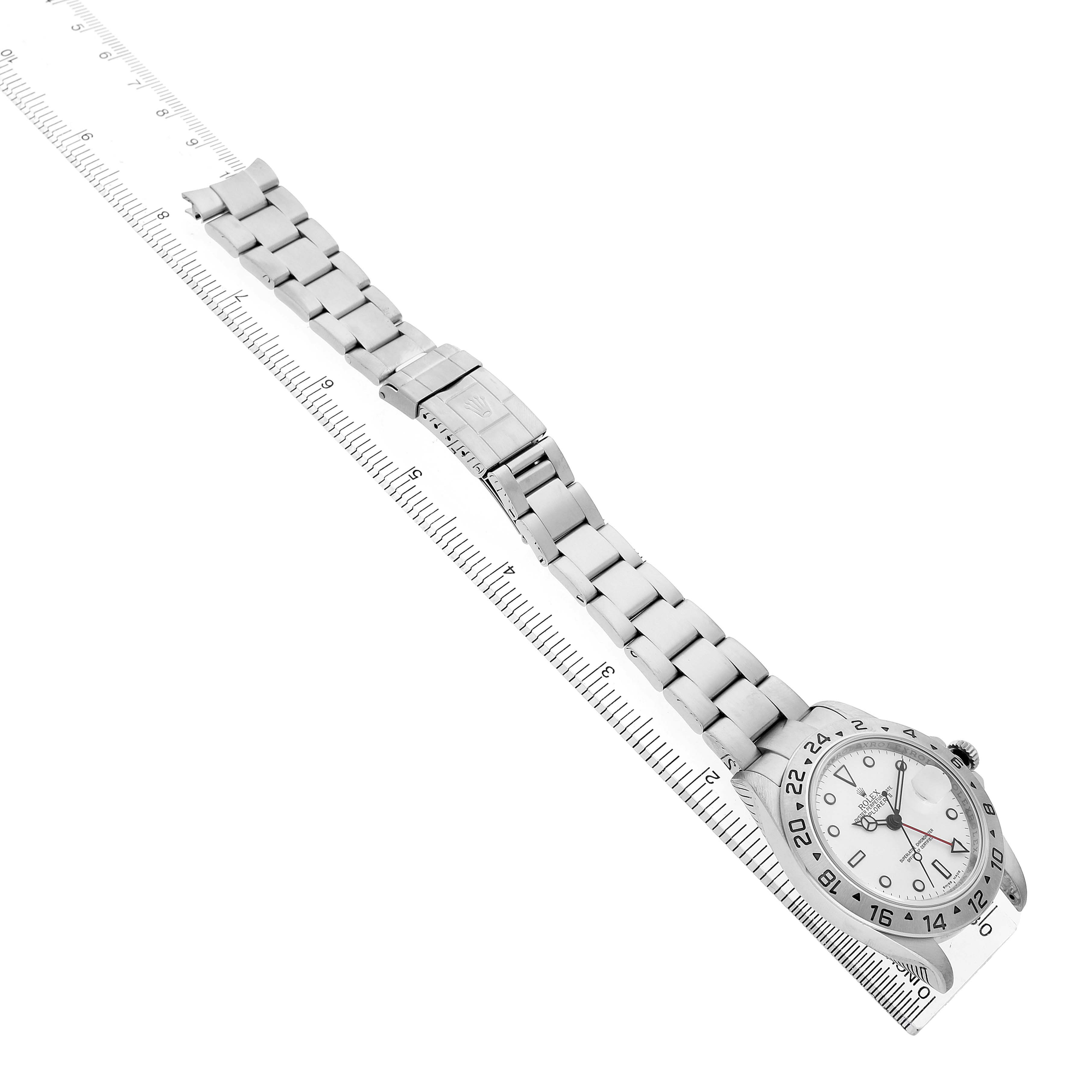 The Rolex Explorer 16570 T Men's Stainless Steel White Dial watch is shown diagonally from the front, featuring its bracelet, clasp, and face with a visible ruler for scale.