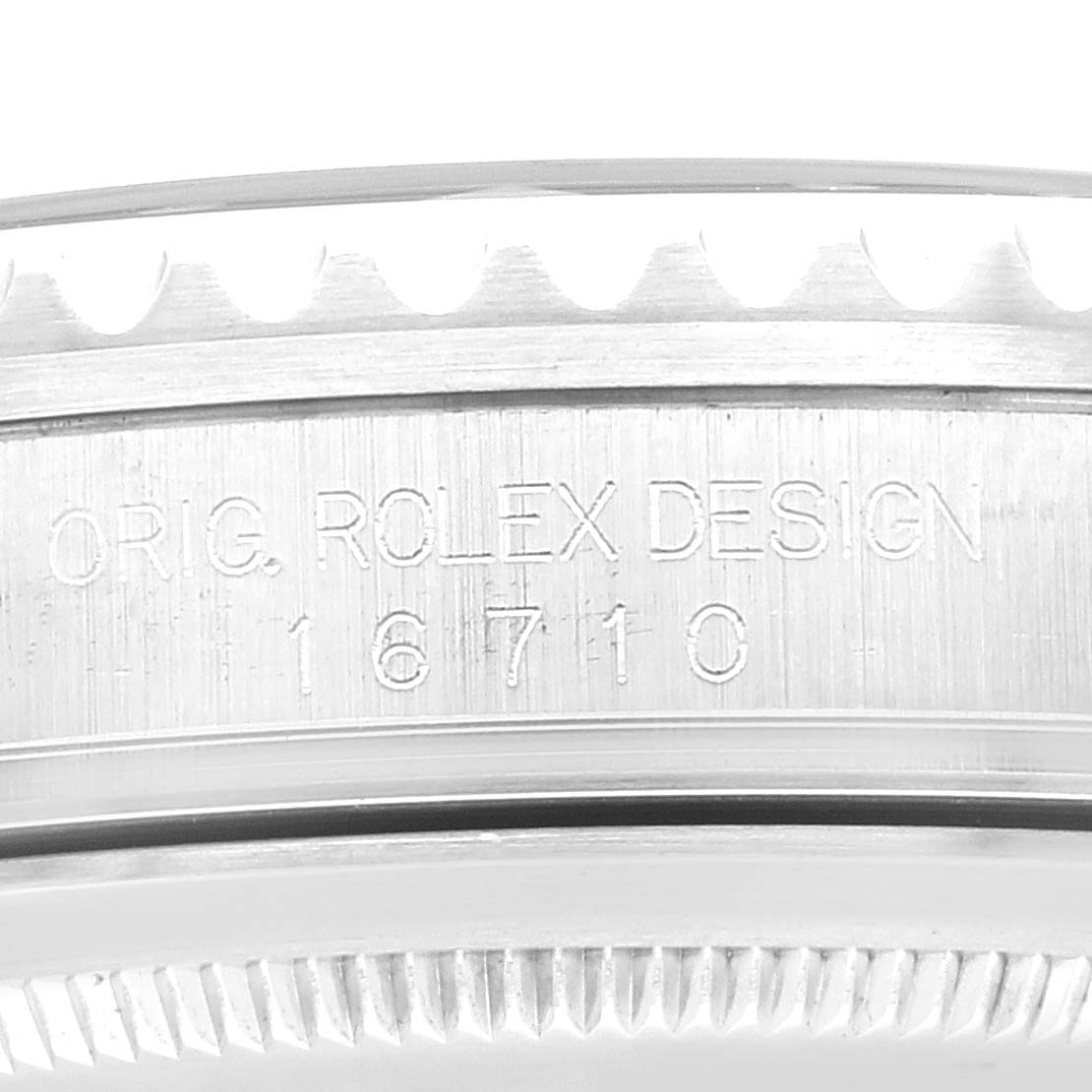 This image shows a close-up of the engraving on the side of the bezel of a Rolex GMT-Master 16710 Men
s Stainless Steel Black Dial 16710 Men
s Stainless Steel Black Dial watch.