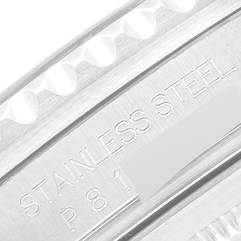 The image shows a close-up of the side of a stainless steel Rolex GMT-Master 16710 Men
s Stainless Steel Black Dial 16710 Men
s Stainless Steel Black Dial watch, focusing on its engraved serial number.