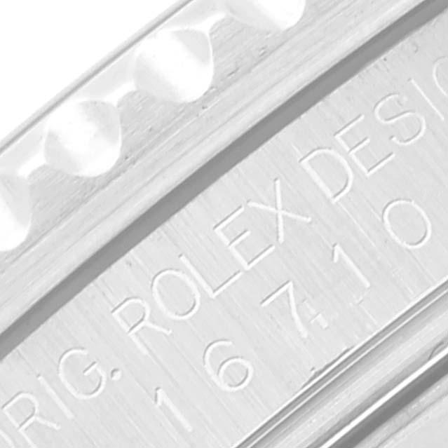 This close-up image shows the engraved model number on the side of a Rolex GMT-Master 16710 Men
s Stainless Steel Black Dial 16710 Men
s Stainless Steel Black Dial watch case.