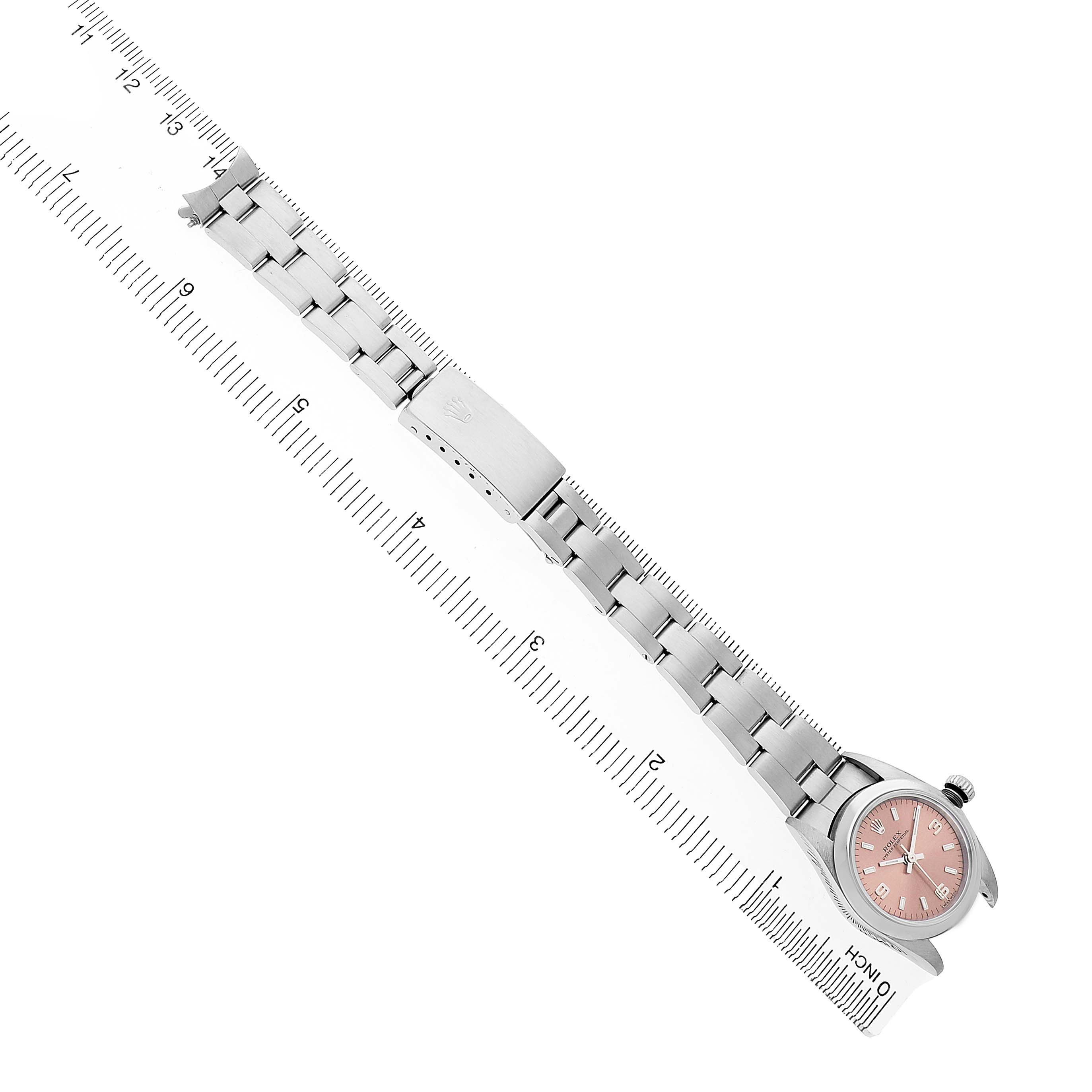 The Rolex Oyster Perpetual 76080 Men's Stainless Steel Pink Dial watch is shown from a top angle, displaying the full bracelet, clasp, and watch face.