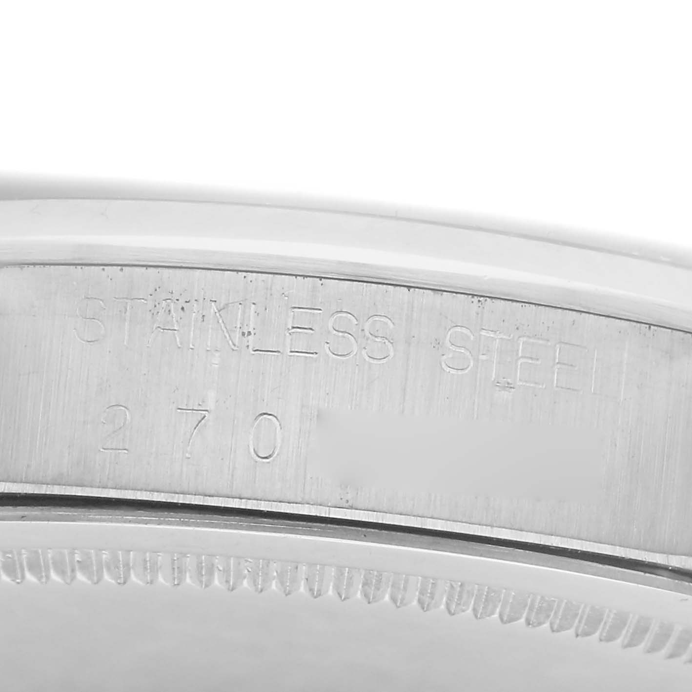 The image shows the side profile of a Rolex Date model 6694 men's watch, highlighting the "STAINLESS STEEL" engraving on the case.