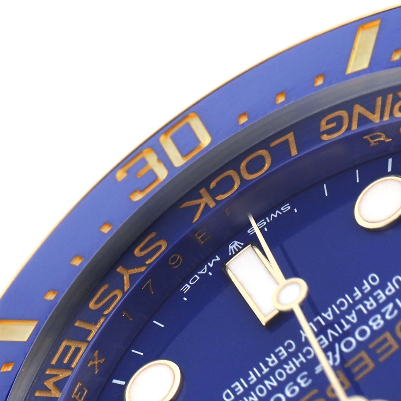 The image shows a close-up of the Rolex Sea-Dweller 136668LB Men's Yellow Gold Blue Dial's blue dial, bezel, and part of the minute hand at an angled view.