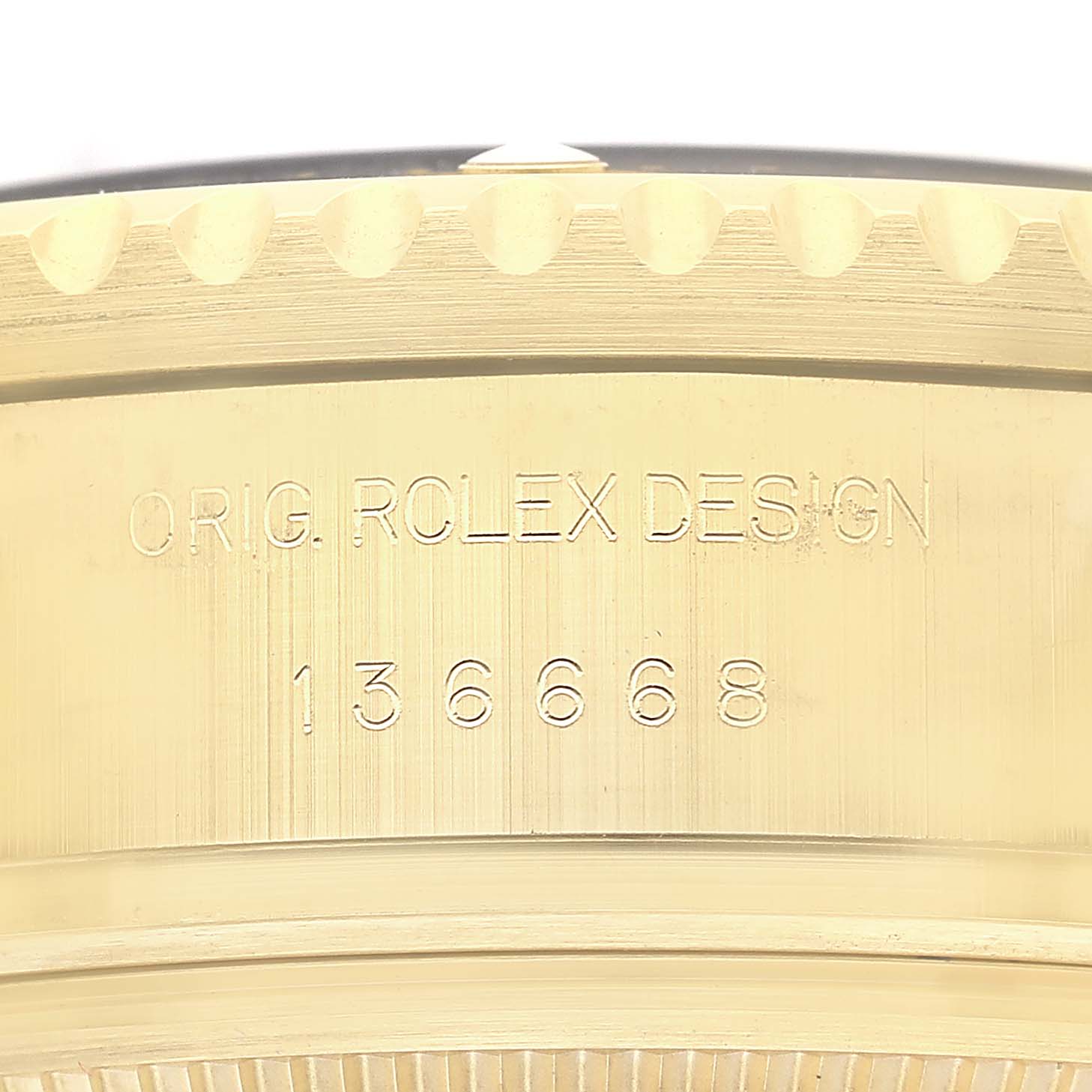 The image shows a close-up side view of the gold case of a Rolex Sea-Dweller 136668LB Men's Yellow Gold Blue Dial, highlighting the model engraving.