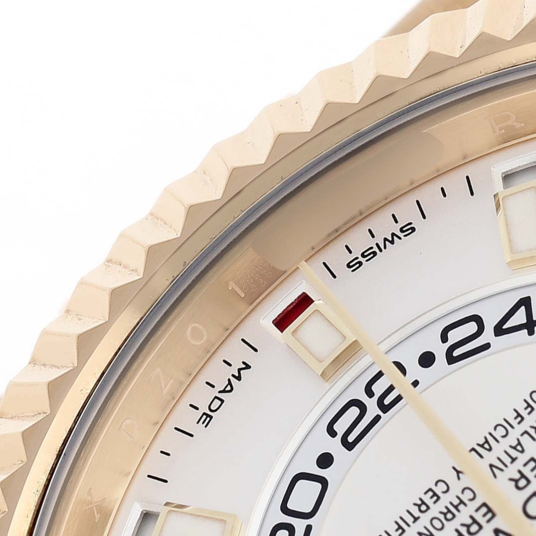 The image shows a detailed close-up of the Rolex Sky-Dweller 326238 Men's Yellow Gold White Dial's bezel, part of the dial, and indices.