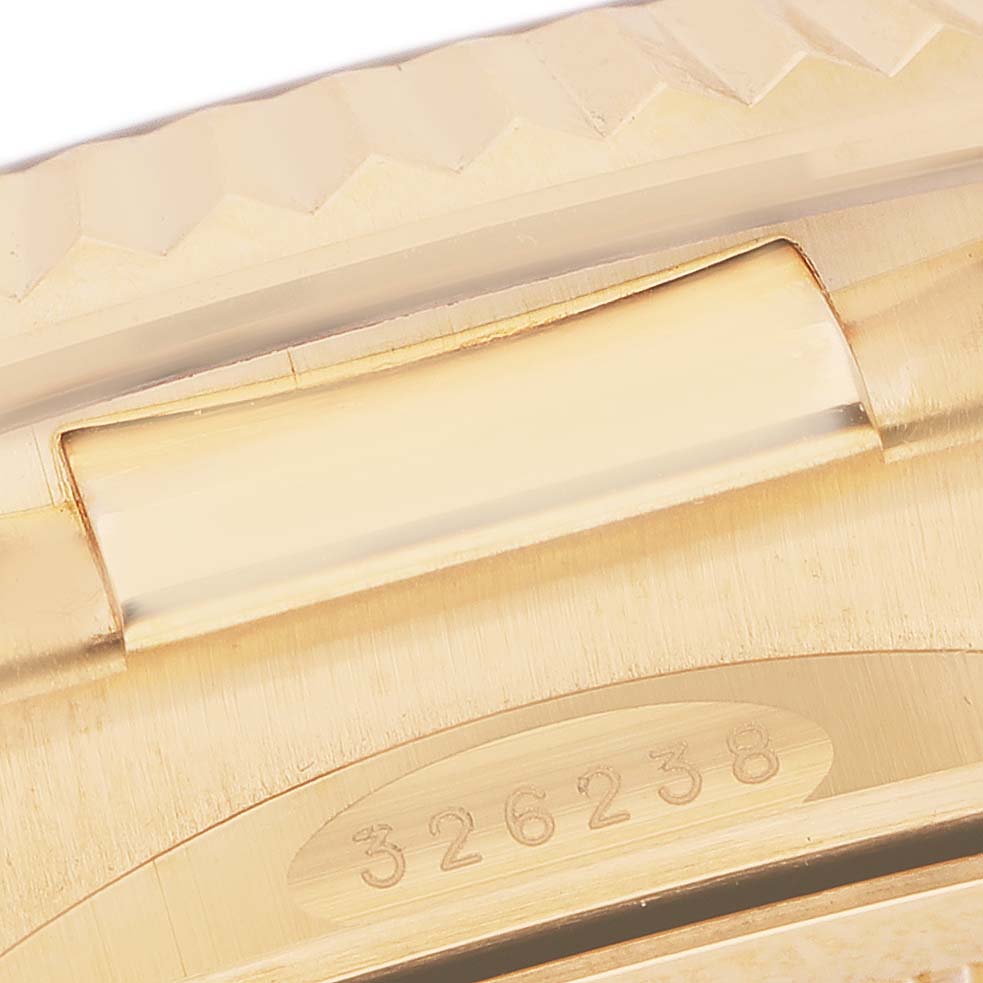 The image shows a close-up of the Rolex Sky-Dweller 326238 Men's Yellow Gold White Dial's gold bracelet, focusing on the engraved serial number.