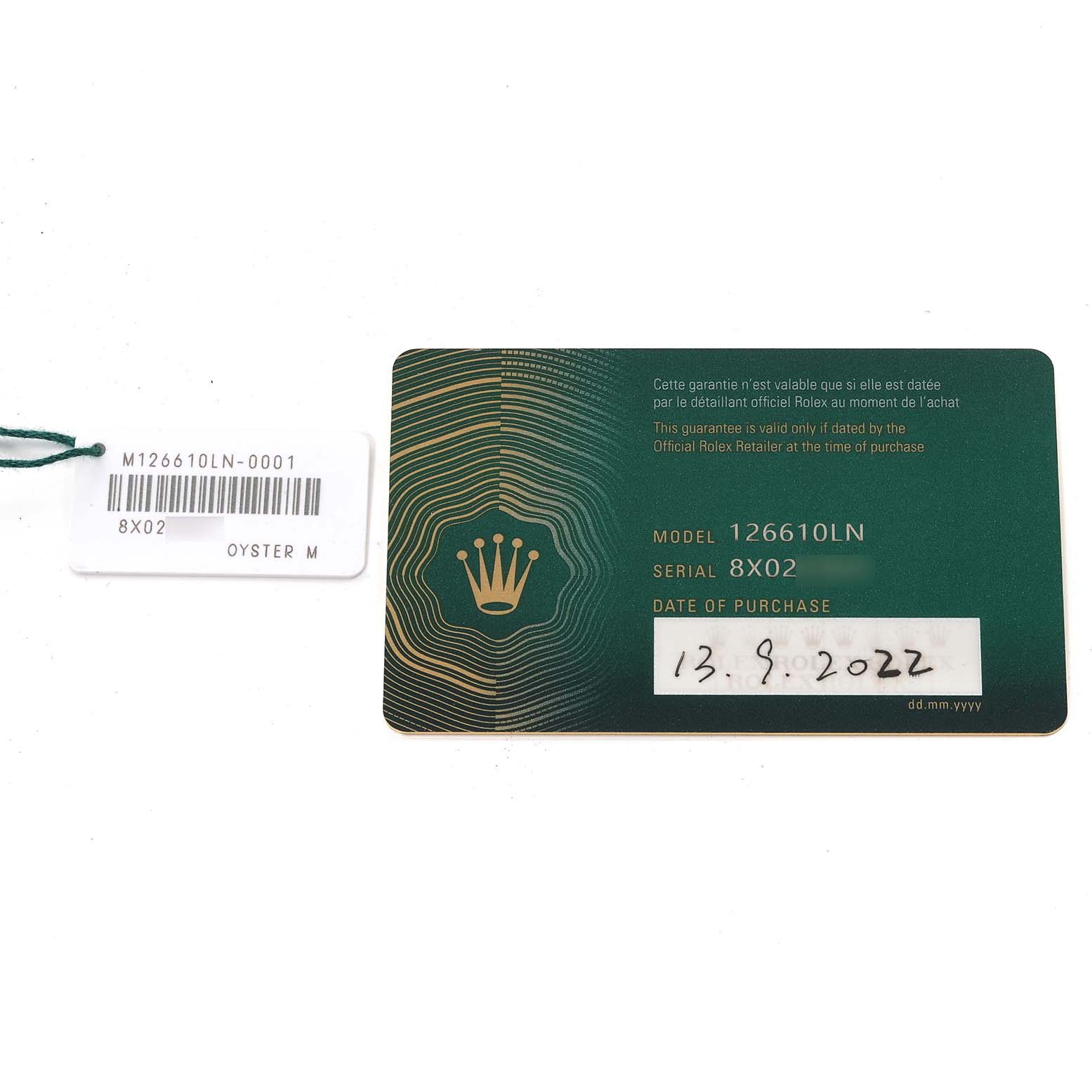 The image shows a warranty card and a tag for a Rolex Submariner 126610 Men
s Stainless Steel Black Dial 126610 Men
s Stainless Steel Black Dial model 126610LN with the serial number 8X02.