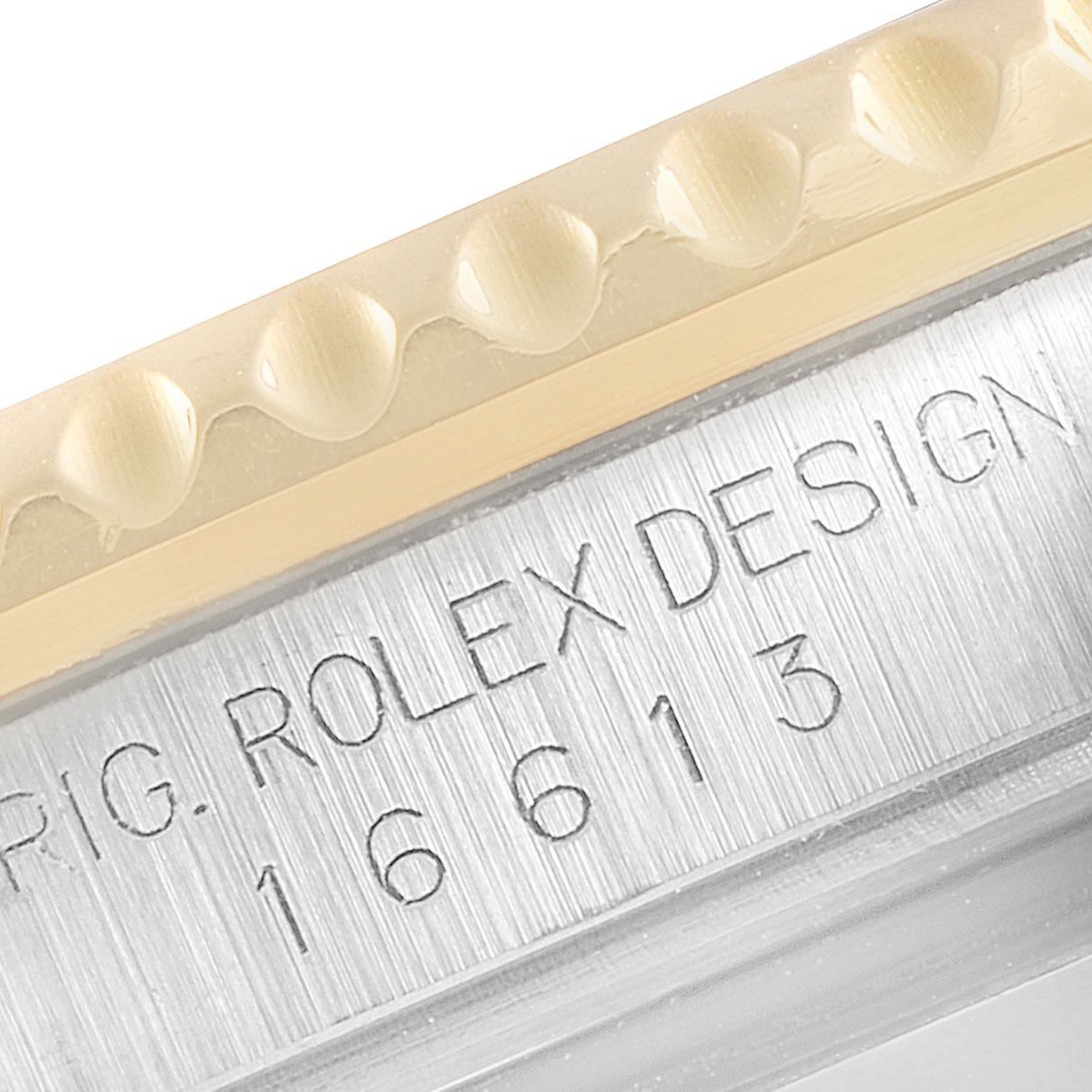 This close-up shows the engraving on the casing and part of the bezel of a Rolex Submariner 16613 Men's Steel and Gold (two tone) Blue Dial 16613 Men's Steel and Gold (two tone) Blue Dial model 16613.