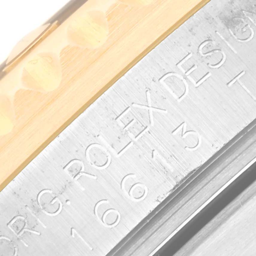 Close-up of the side engraving of the Rolex Submariner 16613 Men's Steel and Gold (two tone) Blue Dial 16613 Men's Steel and Gold (two tone) Blue Dial, featuring the brand's logo and model number.