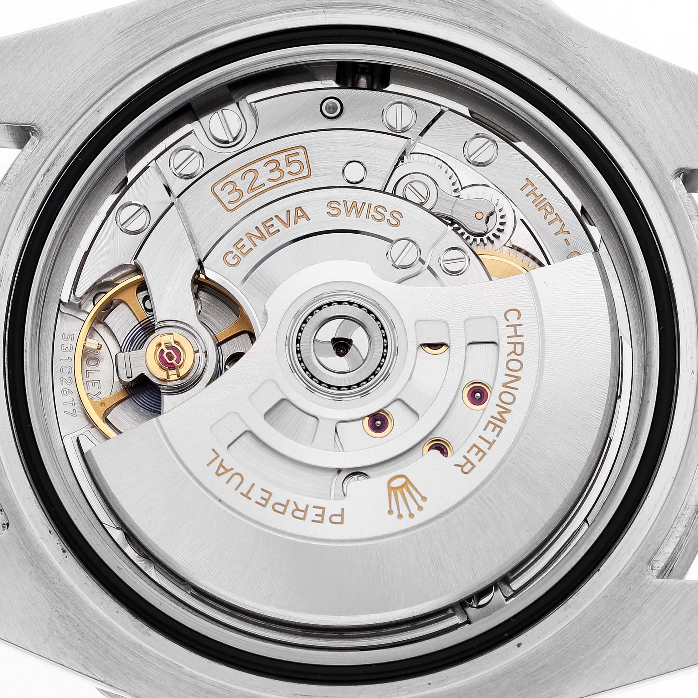 The image shows the Rolex Submariner 126610LN Men's Stainless Steel Black Dial's movement from a rear angle, highlighting elements like the rotor and engravings.