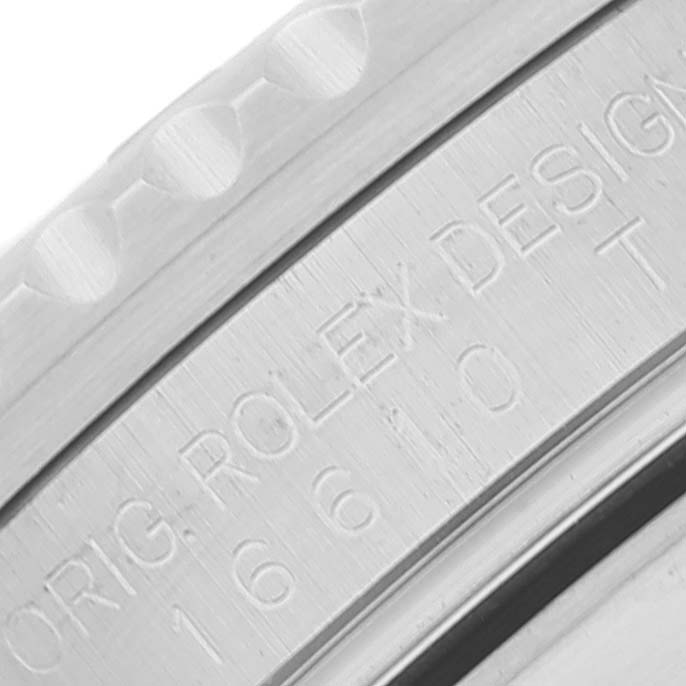 The image shows a close-up of the engraving on the bezel of a Rolex Submariner 16610 Men
s Stainless Steel Black Dial 16610 Men
s Stainless Steel Black Dial watch.