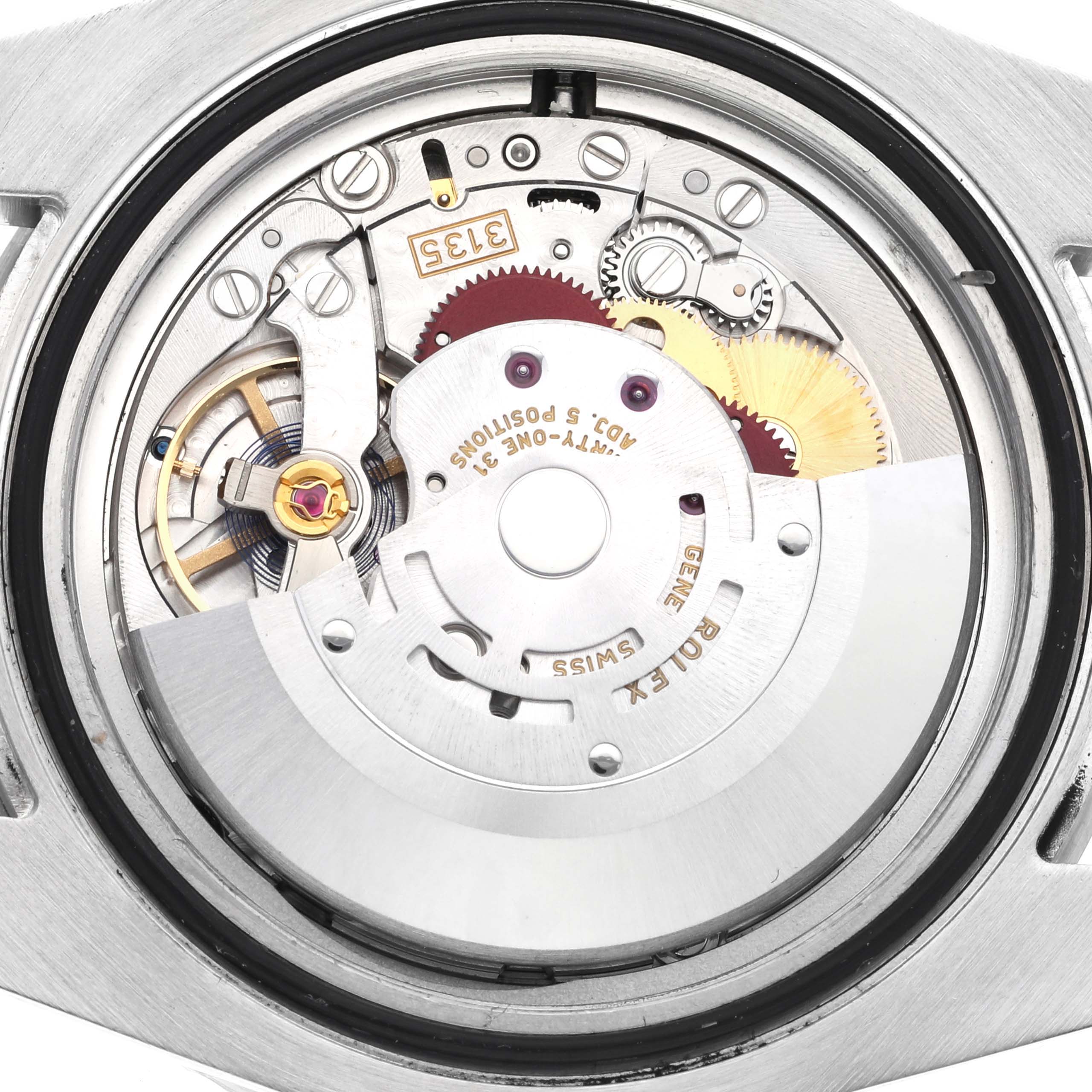 This image shows the internal mechanism of a Rolex Submariner 116610LV Men's Stainless Steel Green Dial 116610LV Men's Stainless Steel Green Dial watch, viewed from the back with various gears and components visible.