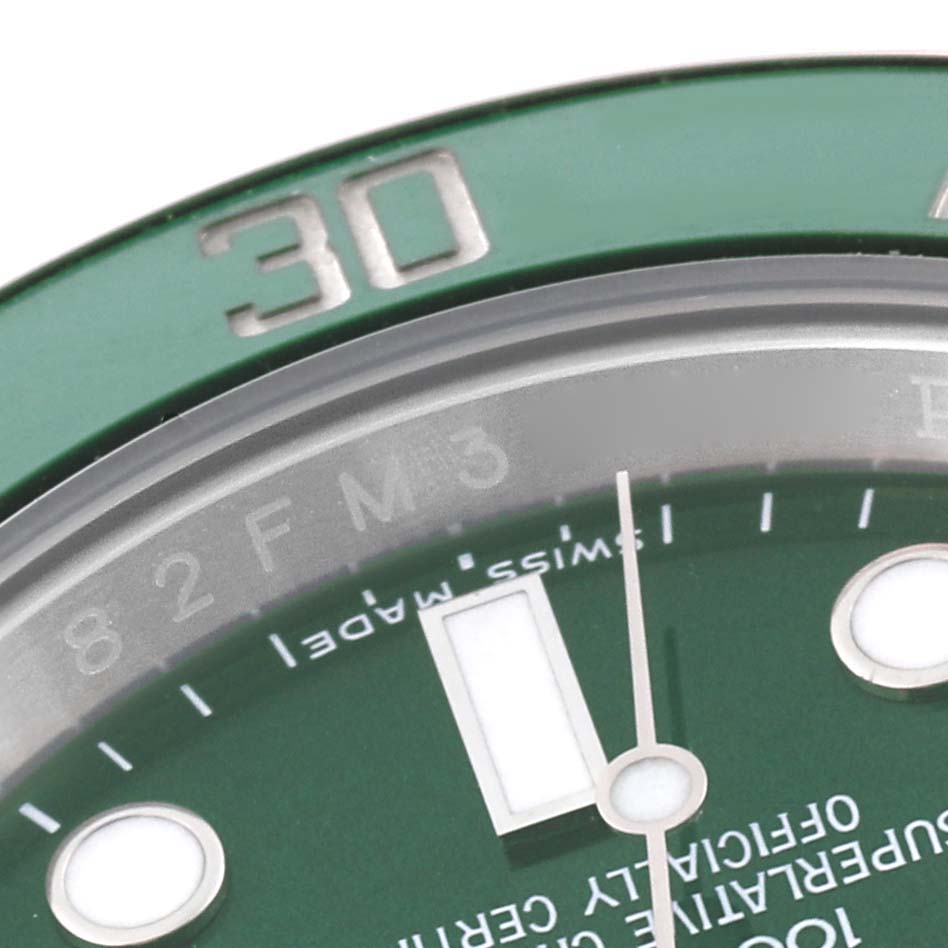 This close-up image of a Rolex Submariner 116610LV Men's Stainless Steel Green Dial 116610LV Men's Stainless Steel Green Dial shows the green bezel, a portion of the green dial, and the hour markers.