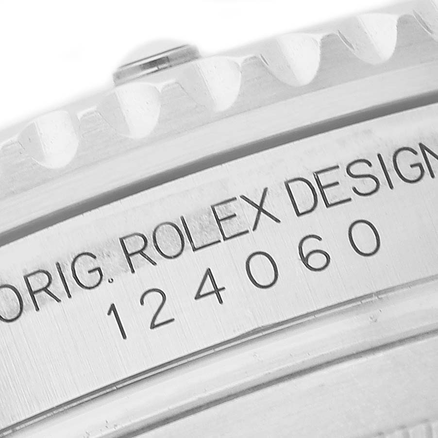 The image shows a close-up of the case side engraving on a Rolex Submariner M124060-0001 Men's Stainless Steel Black Dial watch, displaying the model number.