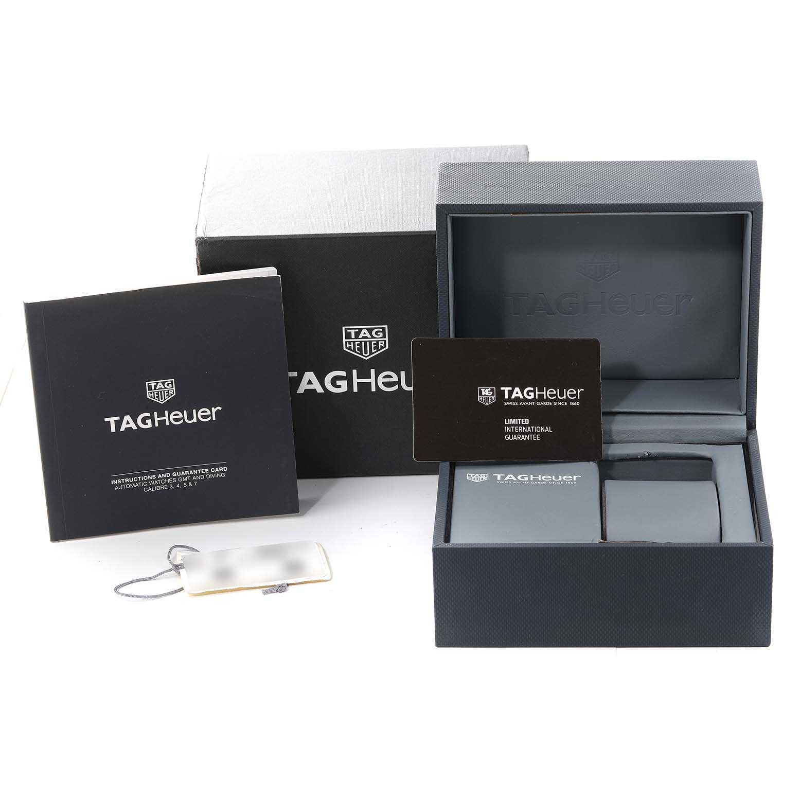 The image shows the packaging and accessories for a Tag Heuer Aquaracer WAY2015.BA0927 Men's Stainless Steel Green Dial WAY2015.BA0927 Men's Stainless Steel Green Dial watch, including the watch box, guarantee card, and instruction booklet.