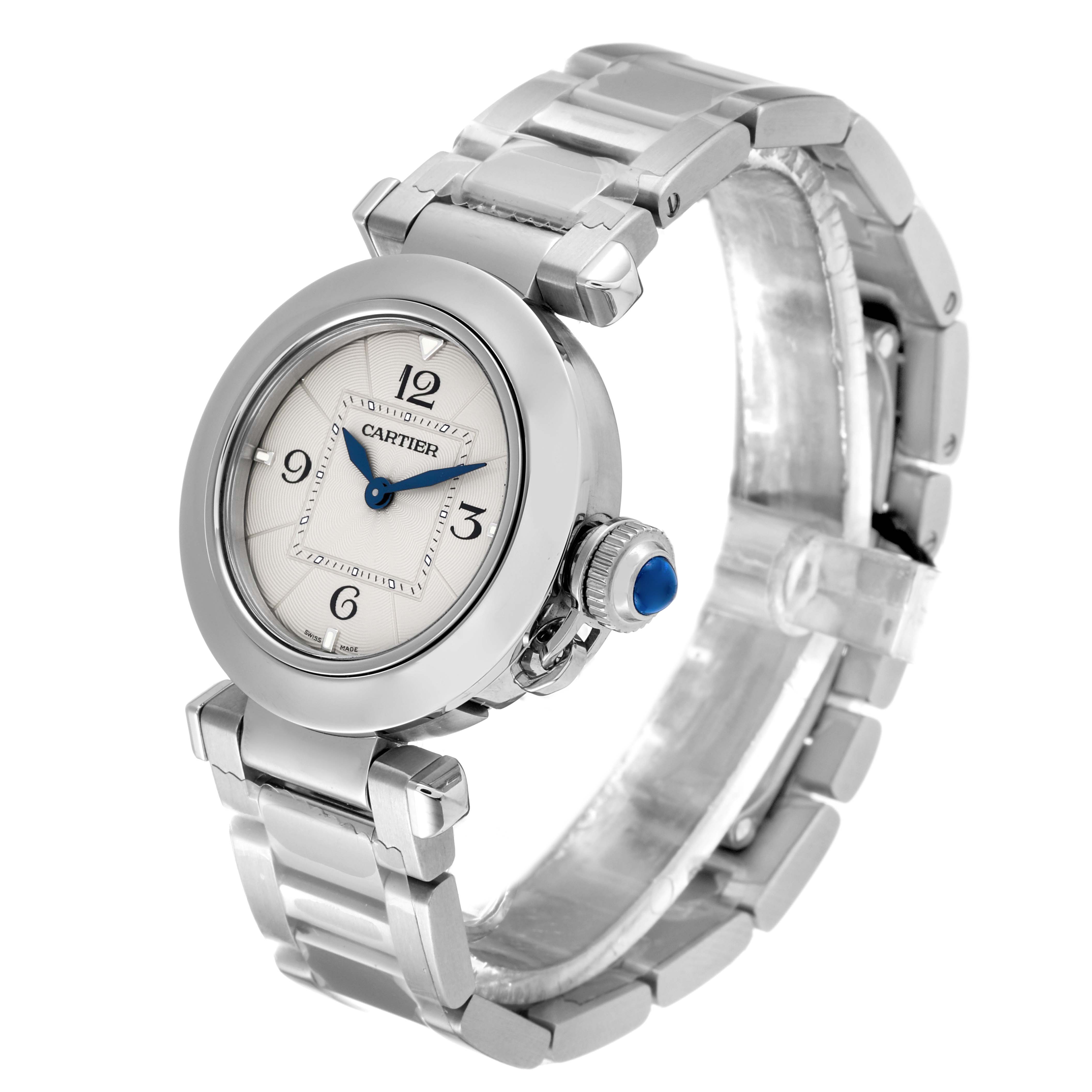 The image shows a Cartier Pasha WSPA0021 Women
s Stainless Steel Silver Dial WSPA0021 Women
s Stainless Steel Silver Dial watch angled slightly to display its face, bracelet, and crown with a blue cabochon.