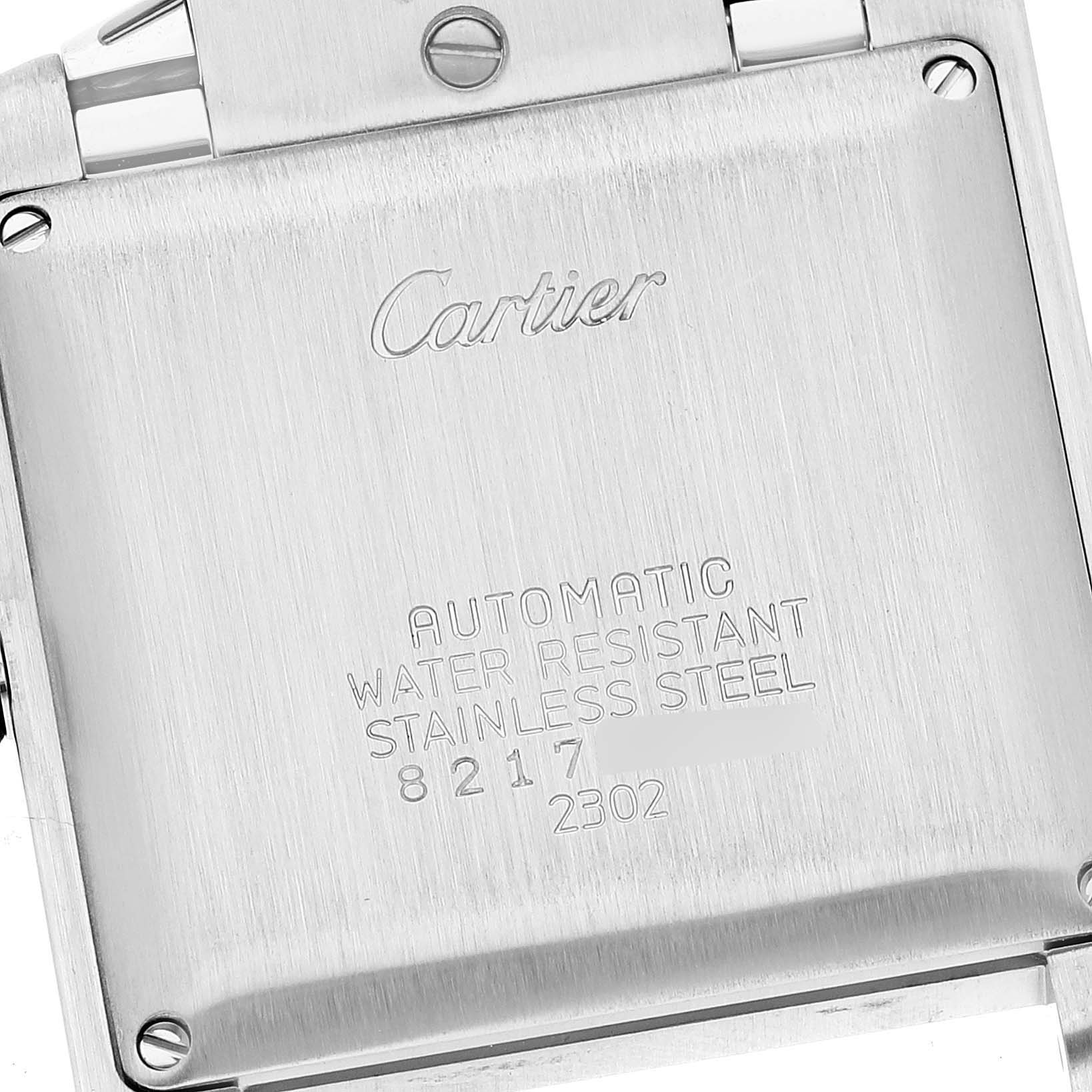 The image shows the back case of a Cartier Tank Francaise W51002Q3 Men
s Stainless Steel Silver Dial W51002Q3 Men
s Stainless Steel Silver Dial watch, highlighting its inscriptions and stainless steel material.
