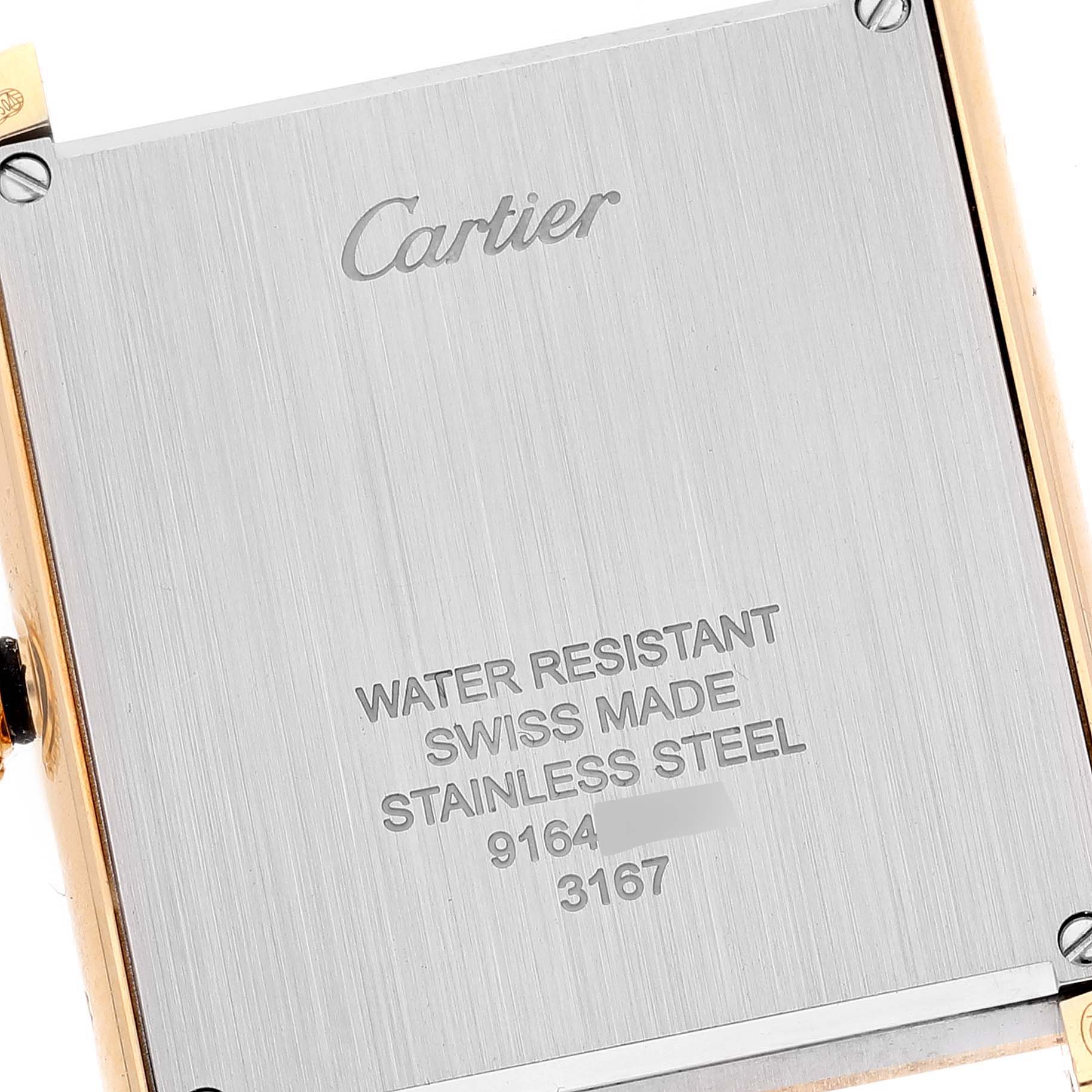 This image shows the back case of a Cartier Tank Solo W5200004 Men
s Yellow Gold Silver Dial W5200004 Men
s Yellow Gold Silver Dial watch, highlighting its engraving and screws.