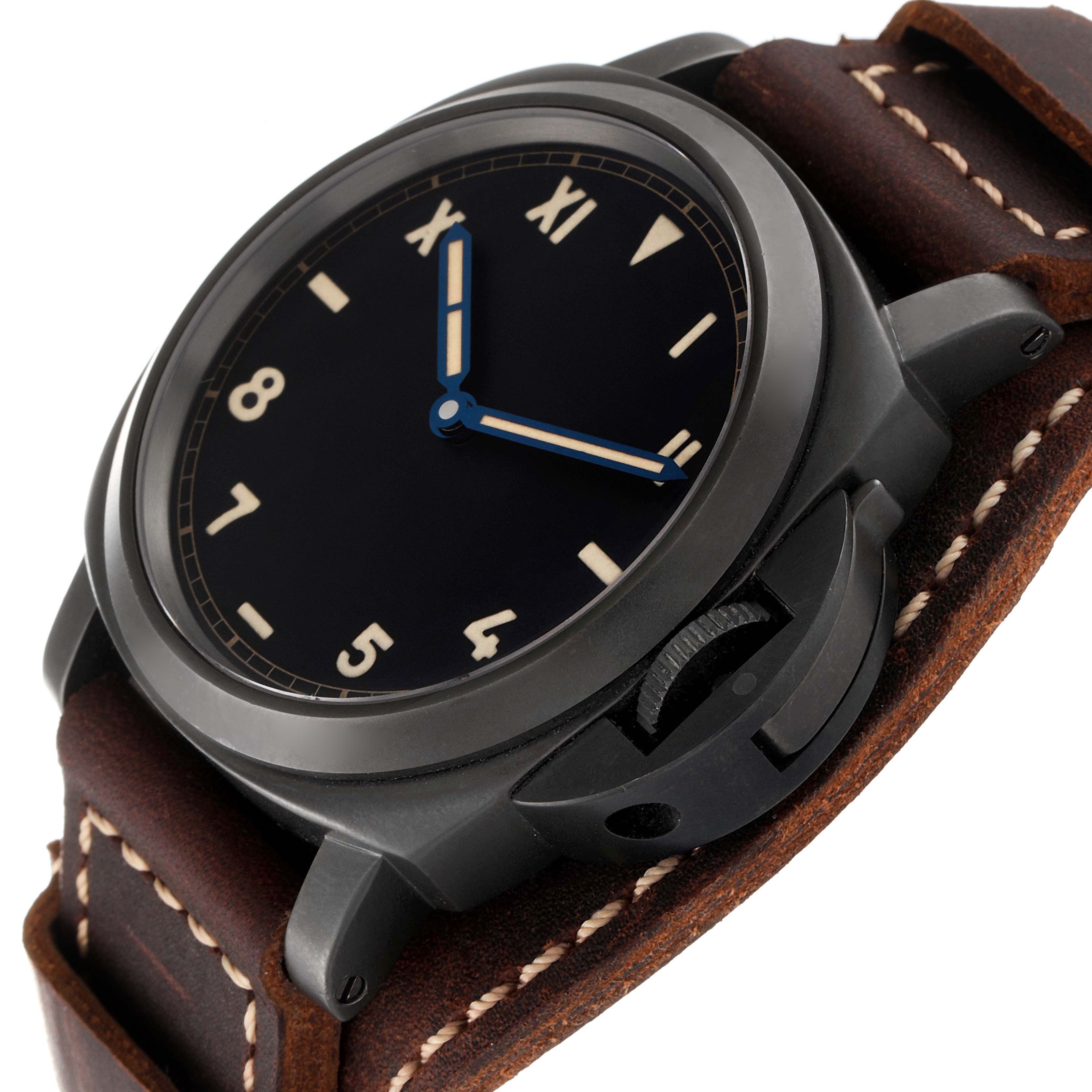 The Panerai Luminor PAM00779 Men
s Titanium Black Dial PAM00779 Men
s Titanium Black Dial watch is shown from a low-angle, highlighting the dial, crown guard, and leather strap.