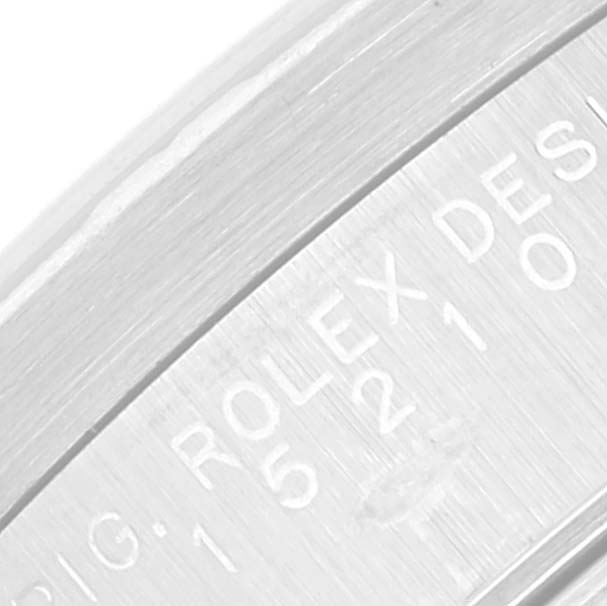 This is a close-up of the side engraving on a Rolex Date 15210 Men's Stainless Steel Blue Dial 15210 Men's Stainless Steel Blue Dial model watch, focusing on the serial and design numbers.