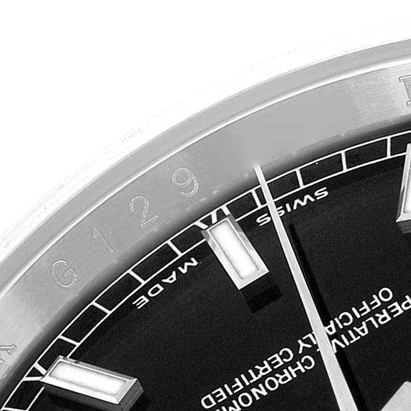 The image shows a close-up of the Rolex Datejust 116200 Men
s Stainless Steel Black Dial 116200 Men
s Stainless Steel Black Dial dial, highlighting the markers, hands, and bezel.