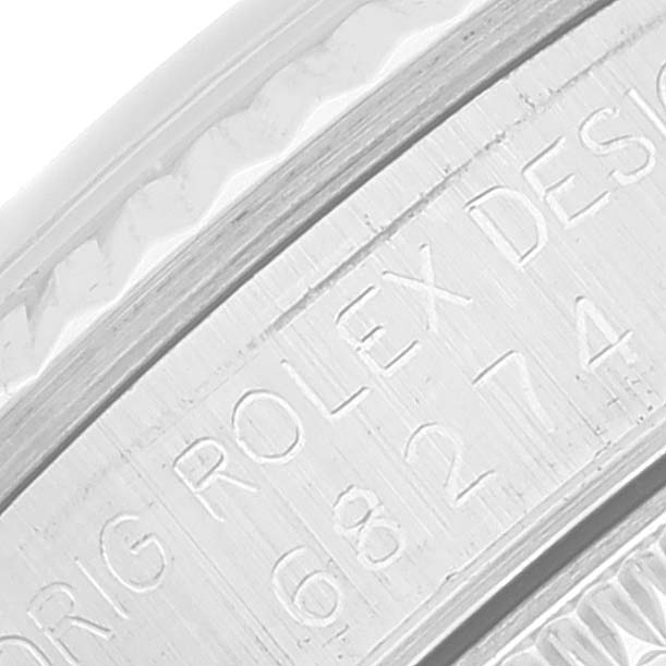 The image shows a close-up of the engraved case side of the Mid-Size Rolex watch.