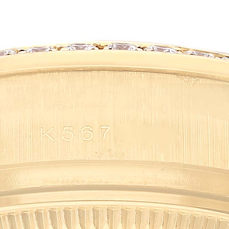 This is a close-up image of the side of a Rolex President 179158 Women's Yellow Gold Champagne Dial 179158 Women's Yellow Gold Champagne Dial model watch, showing the edge of the bezel and part of the case with a serial number.