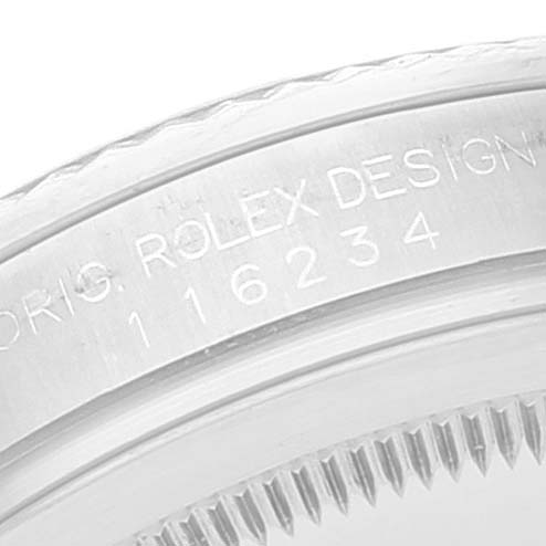 This image shows a close-up of the side engraving on the bezel of a Rolex Datejust 116234 Men's Stainless Steel Blue Dial 116234 Men's Stainless Steel Blue Dial model.