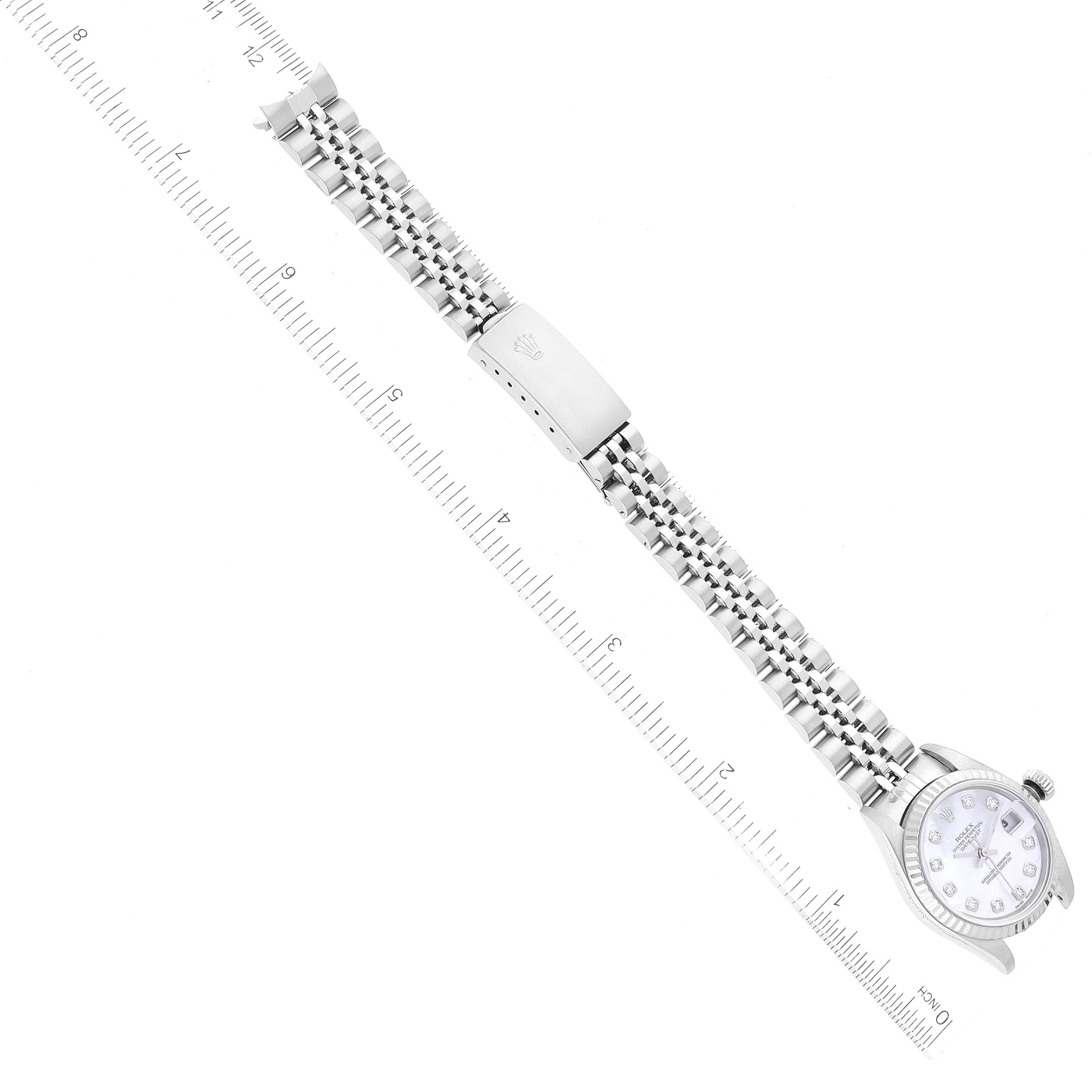 The image shows a top-down view of a Rolex Datejust 79174 Women's Stainless Steel Mother of Pearl Dial 79174 Women's Stainless Steel Mother of Pearl Dial watch fully extended, next to a ruler for scale.