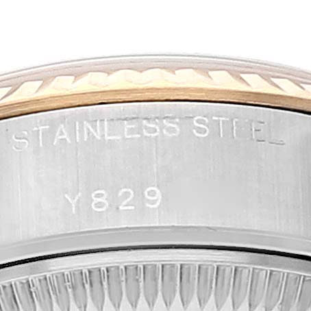 The image shows a close-up of the side of the bezel and case of a Rolex Datejust 79173 Women
s Steel and Gold (two tone) Champagne Dial 79173 Women
s Steel and Gold (two tone) Champagne Dial model watch, focusing on the "Stainless Steel" engraving.