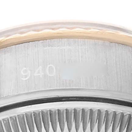 This image shows a close-up of the side of the bezel and case of a Rolex Datejust 69173 Women's Steel and Gold (two tone) White Dial 69173 Women's Steel and Gold (two tone) White Dial watch, revealing part of the serial number.