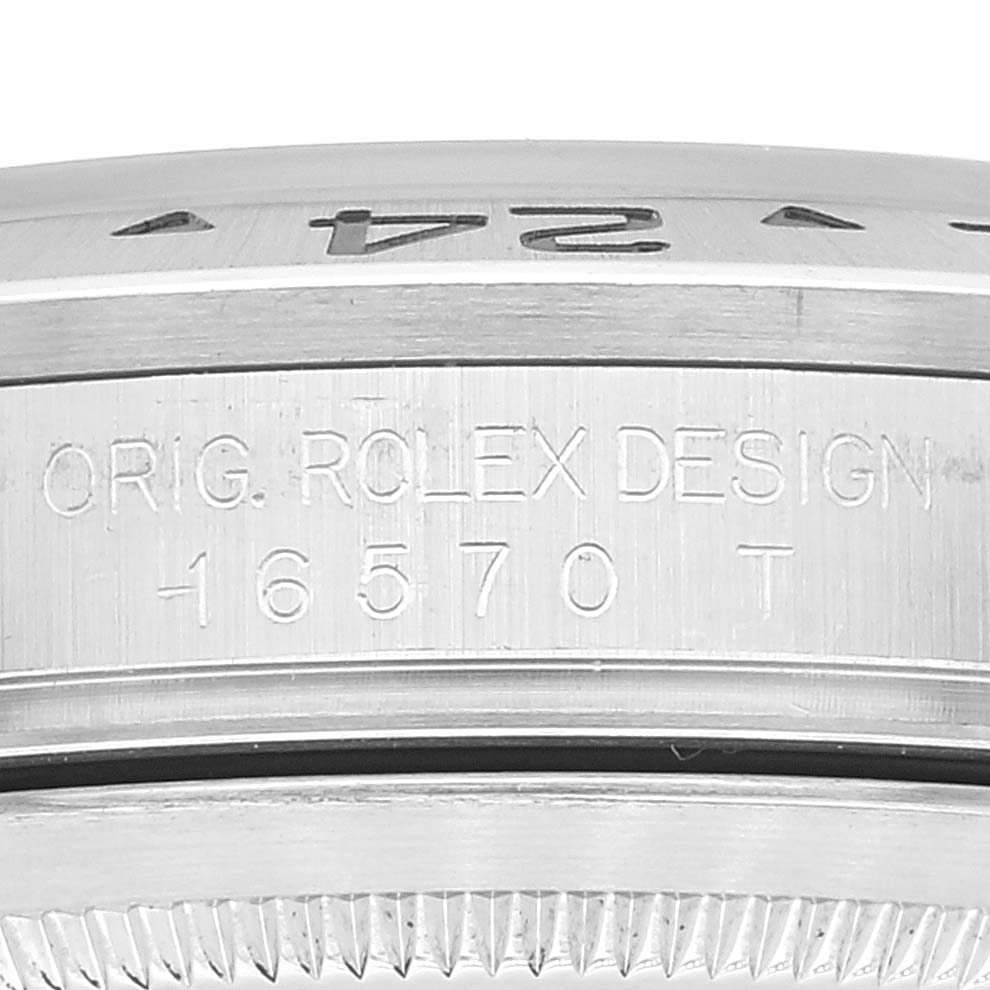 The image shows a close-up of the side of a Rolex Explorer 16570 Men
s Stainless Steel White Dial 16570 Men
s Stainless Steel White Dial model, highlighting the "ORIG. ROLEX DESIGN" and model number engraving.