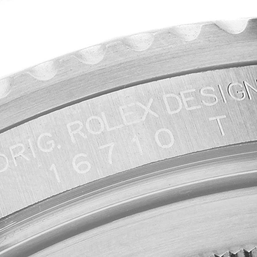 This close-up image shows the engraved serial number and design details on the side of a Rolex GMT-Master 16710 Men
s Stainless Steel Black Dial 16710 Men
s Stainless Steel Black Dial watch bezel.