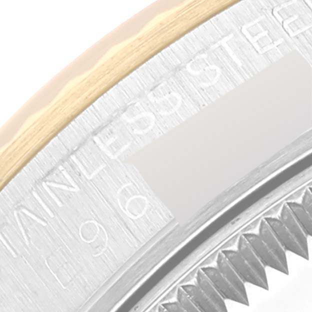 The image shows a close-up of the bezel and part of the case back of a Rolex Mid-Size 67513 Women's Steel and Gold (two tone) Champagne Dial 67513 Women's Steel and Gold (two tone) Champagne Dial model watch.