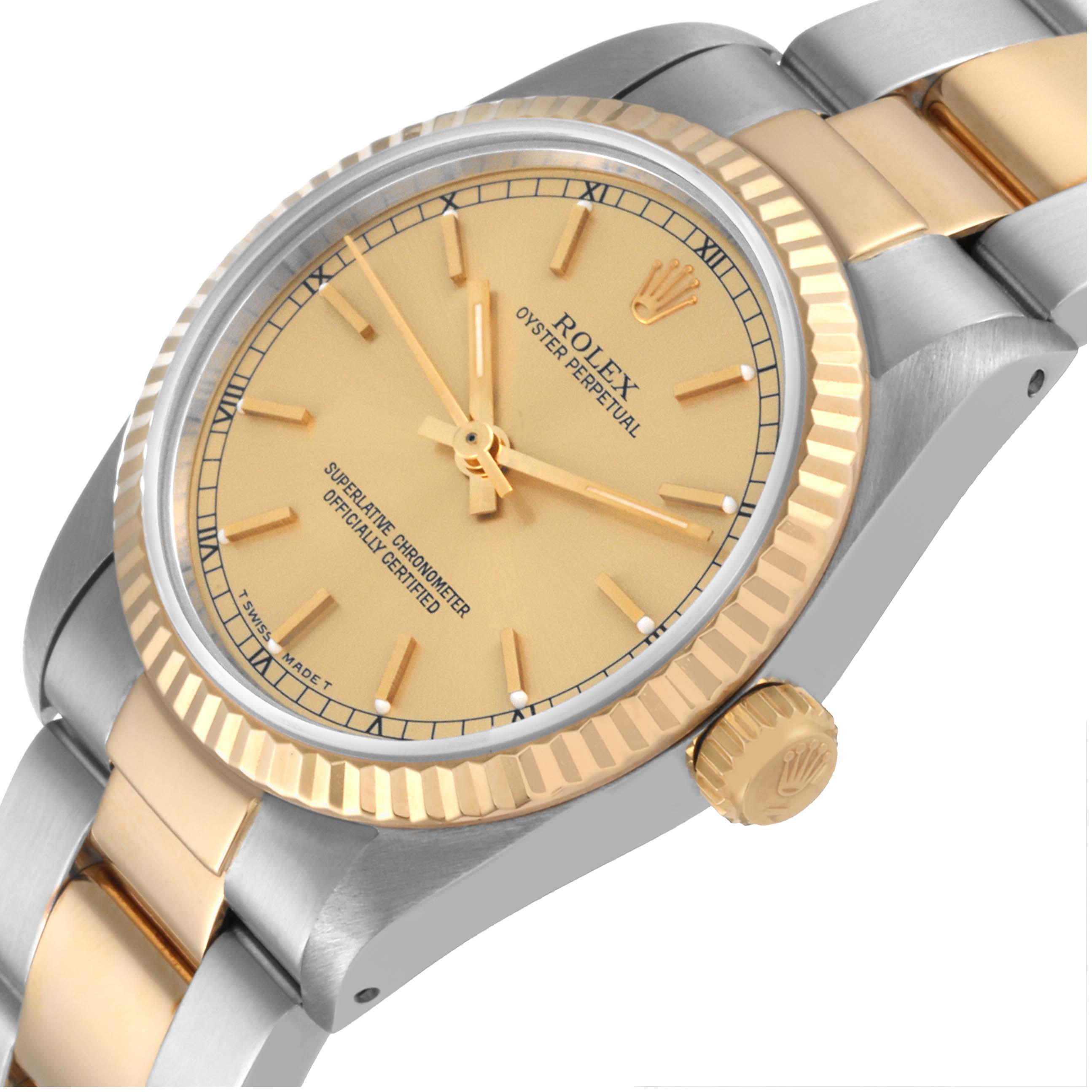 The image shows a side-close angle of a Rolex Mid-Size 67513 Women's Steel and Gold (two tone) Champagne Dial 67513 Women's Steel and Gold (two tone) Champagne Dial Oyster Perpetual watch, highlighting the dial, bezel, and crown.