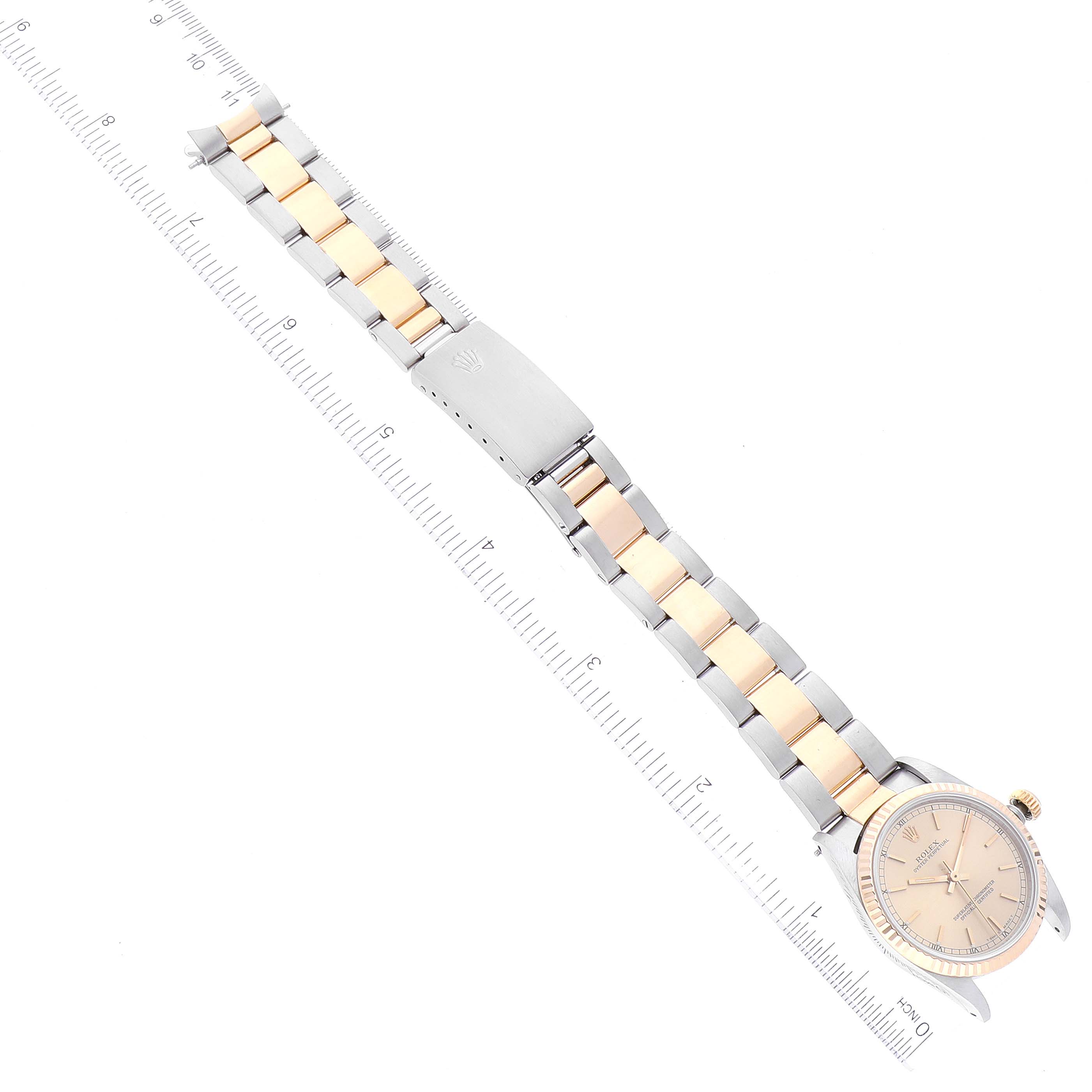 The image shows a top-down view of a Mid-Size Rolex watch, including the face, bracelet, and clasp alongside a ruler.