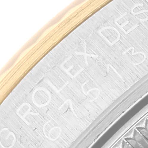 Close-up view of the side of a Rolex Mid-Size 67513 Women's Steel and Gold (two tone) Champagne Dial 67513 Women's Steel and Gold (two tone) Champagne Dial model, showing the engraved brand name and serial number on the watch case.