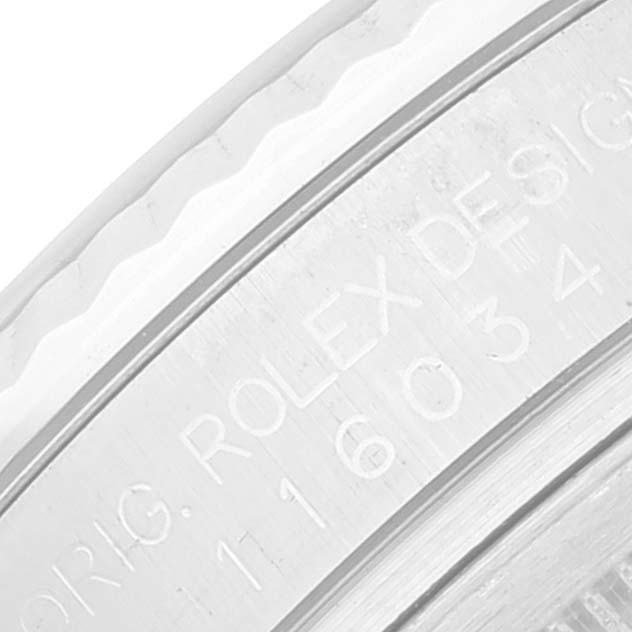 This close-up image of a Rolex Oyster Perpetual 116034 Men's Stainless Steel Silver Dial 116034 Men's Stainless Steel Silver Dial model showcases the engraved design details on its metal case back.