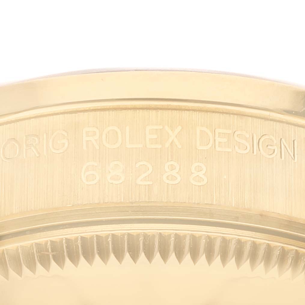 The image shows a close-up of the side of a Rolex President 68288 Women
s Yellow Gold Champagne Dial 68288 Women
s Yellow Gold Champagne Dial model, highlighting the engraved "ORIG ROLEX DESIGN 68288".