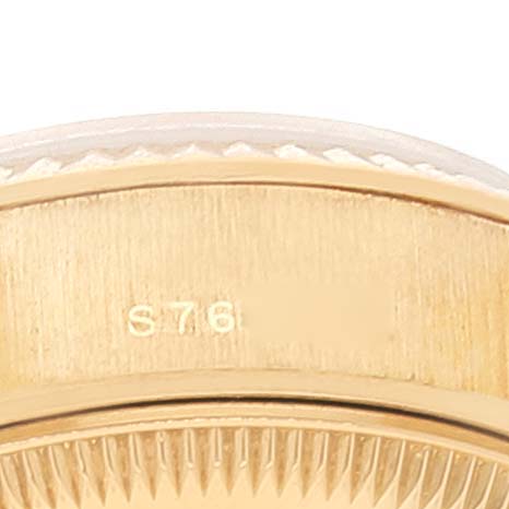 This close-up image shows the side of a Rolex President 69178 Women
s Yellow Gold Champagne Dial 69178 Women
s Yellow Gold Champagne Dial model watch, focusing on the case and bezel with a visible serial number.
