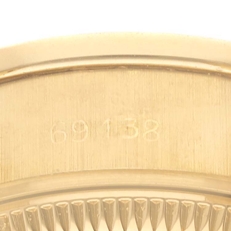 This image shows a close-up view of the model number "69158" engraved on a gold Rolex President 69138 Women
s Yellow Gold Champagne Dial 69138 Women
s Yellow Gold Champagne Dial watch bezel.