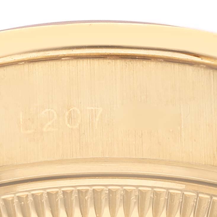 The image shows a close-up of the engraved bezel and case of the Rolex President 69138 Women
s Yellow Gold Champagne Dial 69138 Women
s Yellow Gold Champagne Dial model watch.