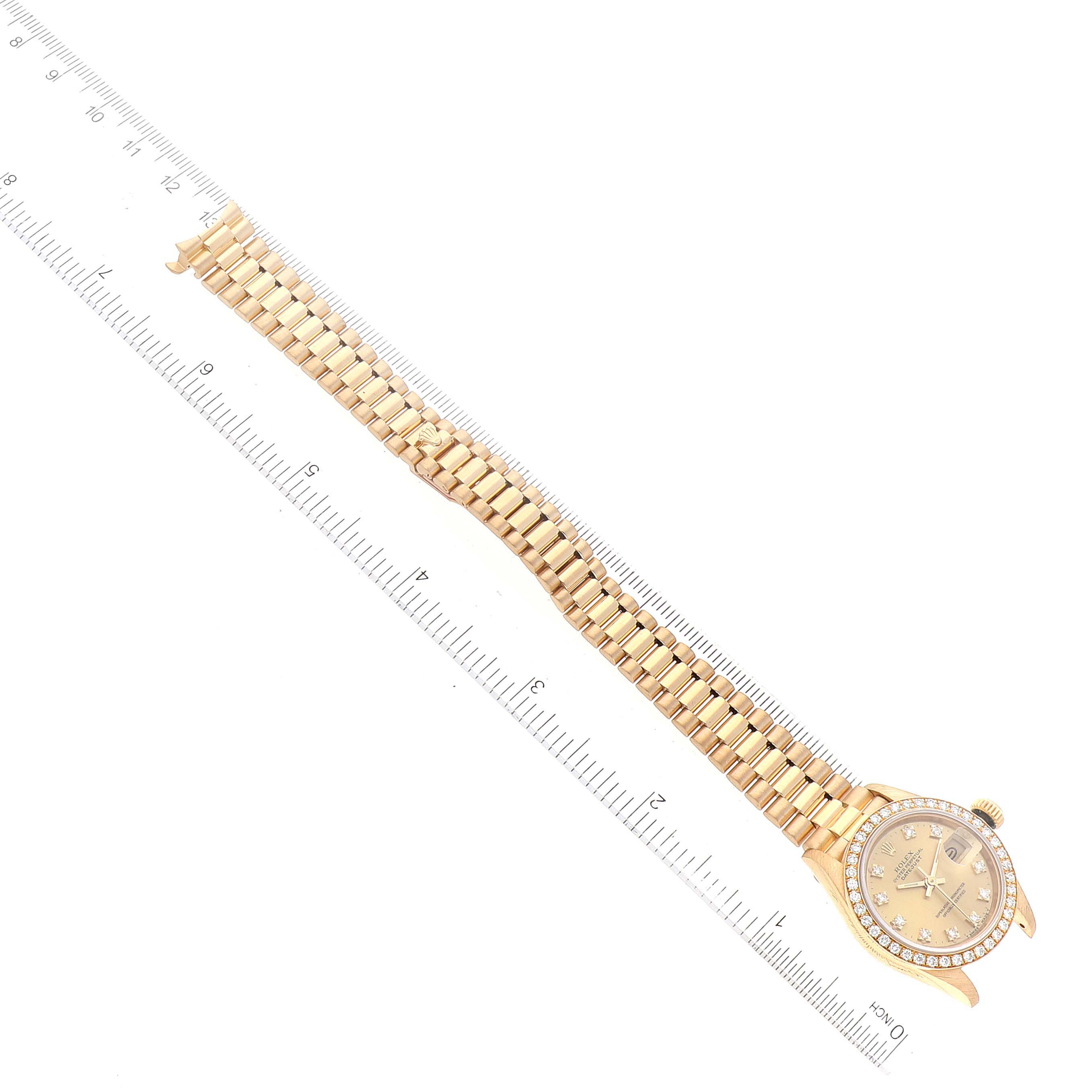 This image shows the Rolex President 69138 Women
s Yellow Gold Champagne Dial 69138 Women
s Yellow Gold Champagne Dial model watch from a top-down angle, displaying its face and full bracelet.