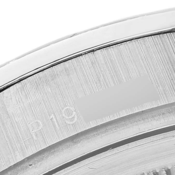 This image shows a close-up of the bezel and part of the case back of a Rolex President 118346 Men's Platinum Black Dial 118346 Men's Platinum Black Dial model watch.