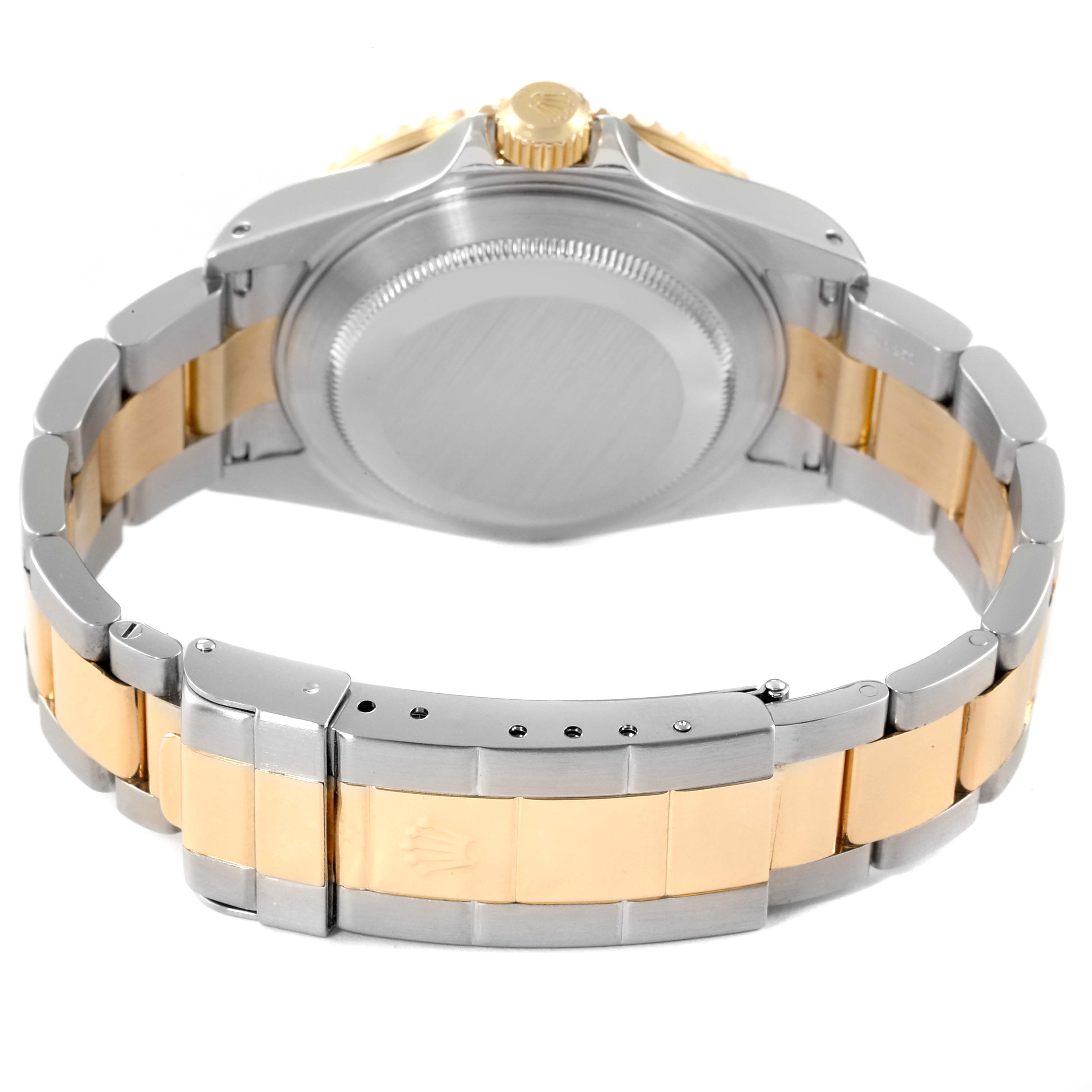 The image shows the rear view of a Rolex Submariner 16613 Men's Steel and Gold (two tone) Black Dial 16613 Men's Steel and Gold (two tone) Black Dial watch, highlighting its two-tone bracelet and closed case back.