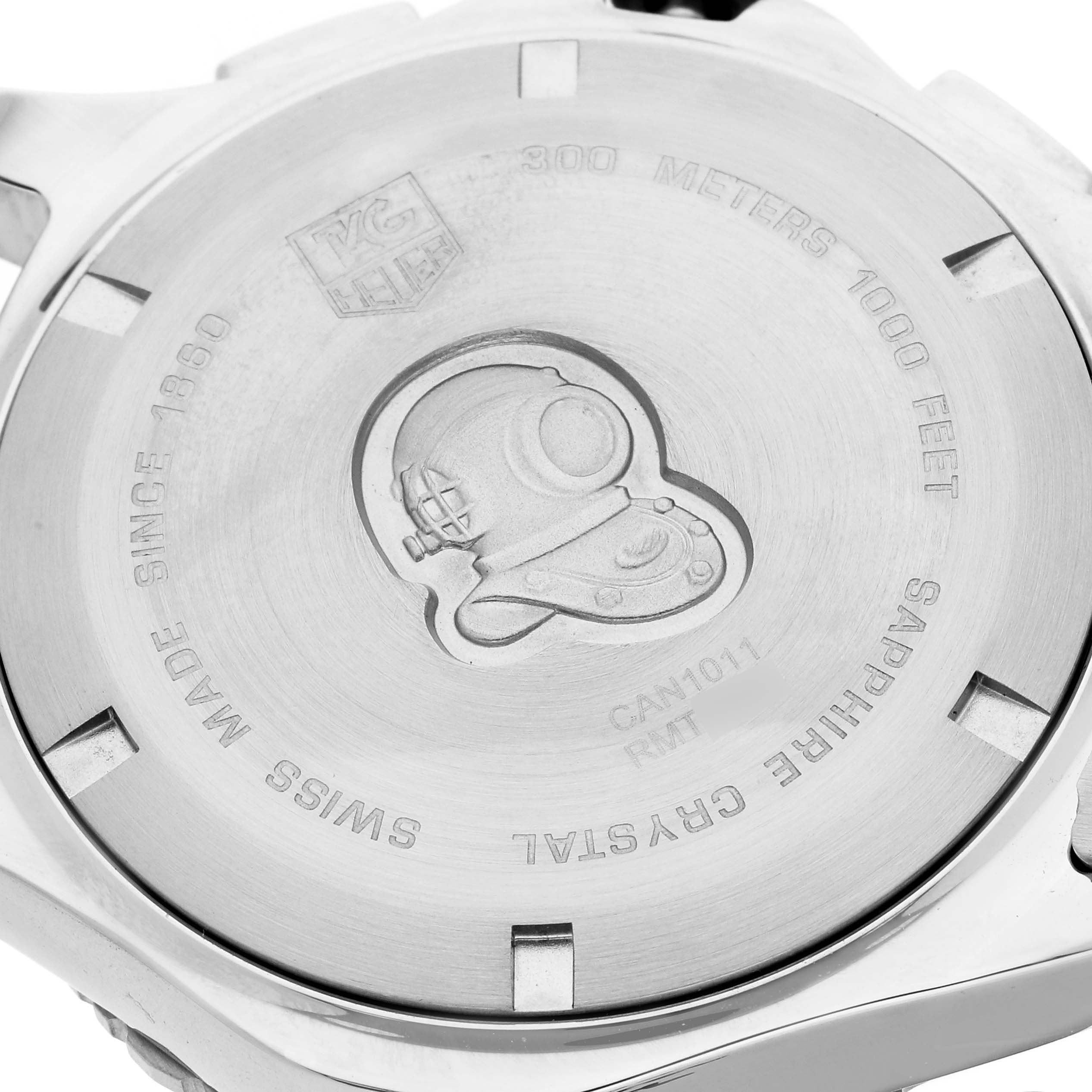 The image shows the stainless steel back casing of a Tag Heuer Aquaracer CAN1011.BA0821 Men's Stainless Steel Blue Dial CAN1011.BA0821 Men's Stainless Steel Blue Dial watch, featuring engraved details and a diver's helmet.