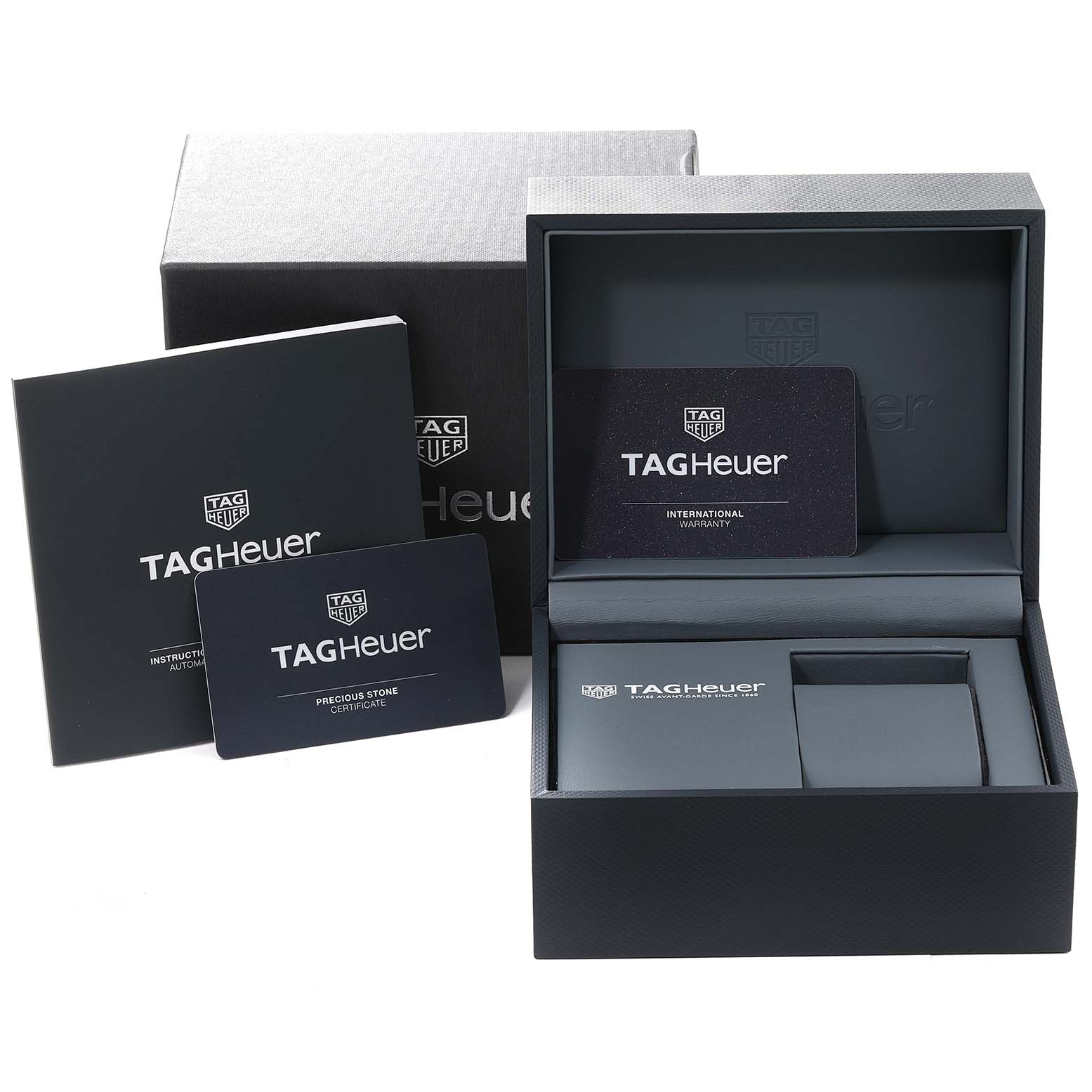 The image shows the packaging and accessories for the Tag Heuer Carrera WAR2452.BD0777 Women's Steel and Gold (two tone) Mother of Pearl Dial WAR2452.BD0777 Women's Steel and Gold (two tone) Mother of Pearl Dial model, including manuals, warranty card, and a presentation box.