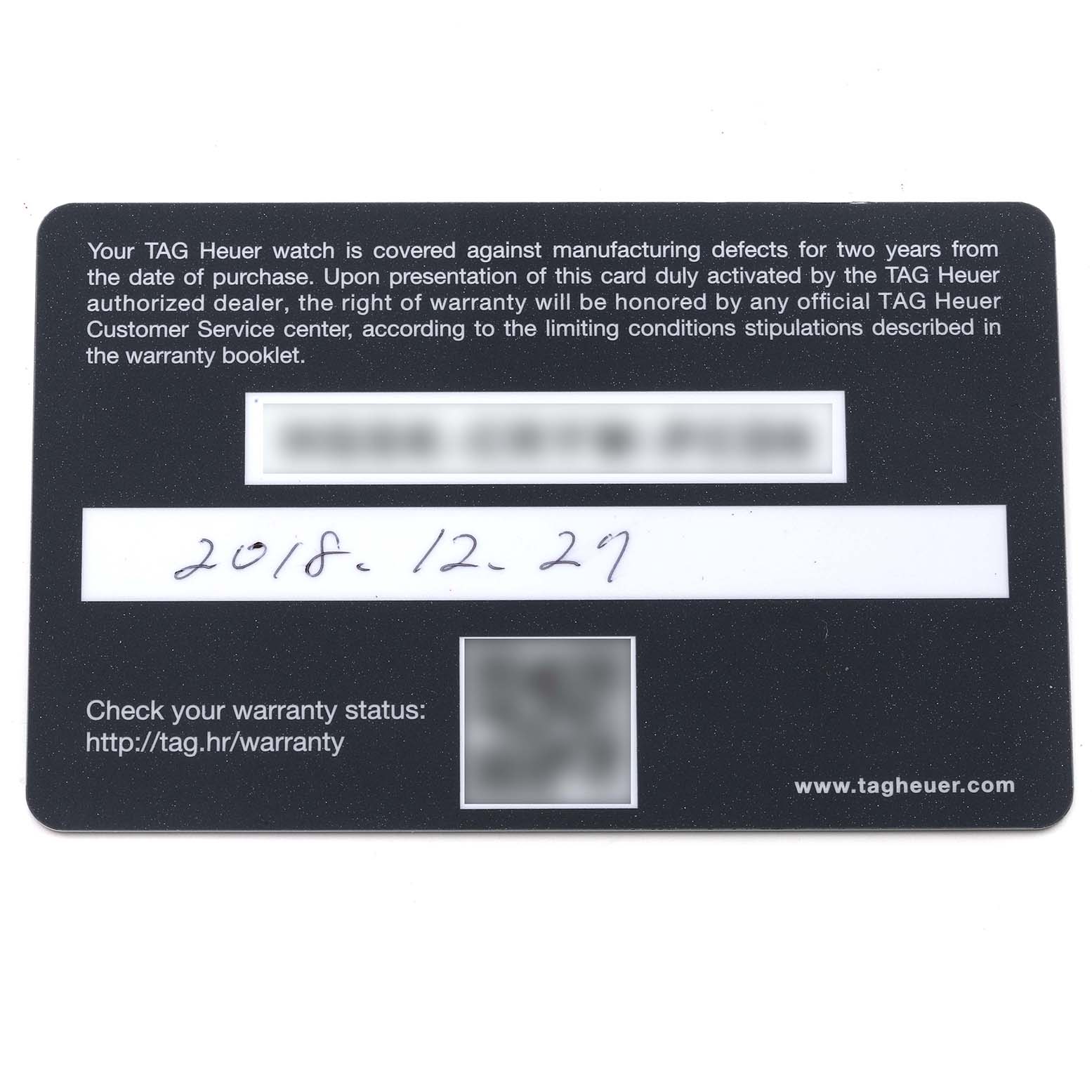 This is a warranty card for the Carrera model by Tag Heuer, photographed from a top-down angle.