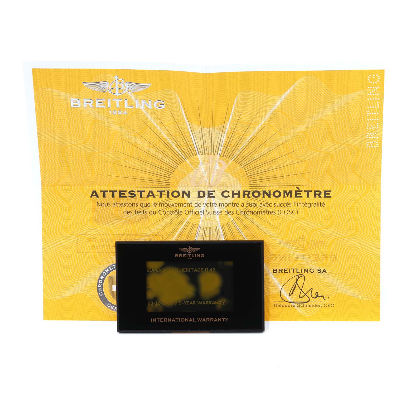 The image shows warranty cards and documentation for the Superocean model by Breitling.