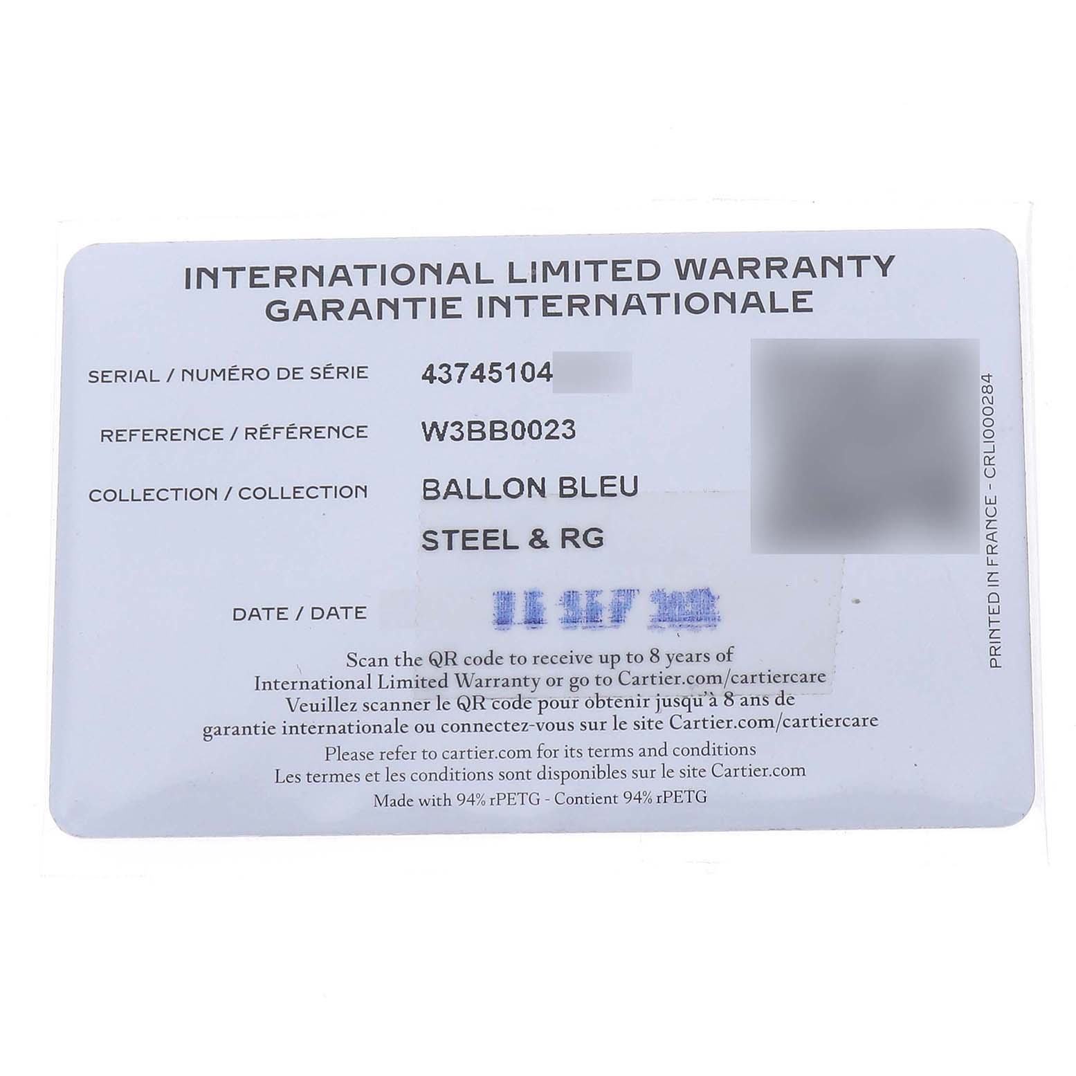 The image shows an international limited warranty card for the Cartier Ballon Bleu W3BB0023 Women's Steel and Gold (two tone) White Dial model, featuring serial and reference details.